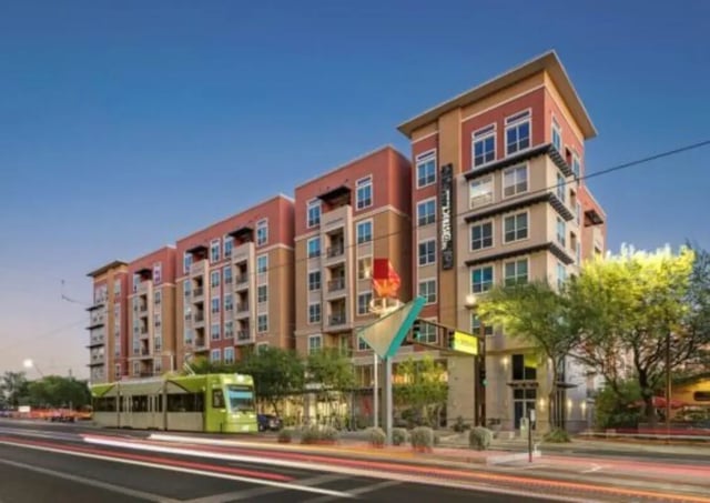 Apartment building with tram and street exterior at The District on Apache in Tempe Student Accommodation