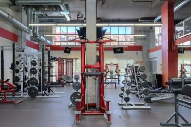 Weight racks machines and dumbbells gym area at The District on Apache in Tempe Student Accommodation