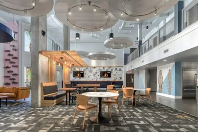 Modern common area with tables chairs and sofa lounge living room at The District on Apache in Tempe Student Accommodation