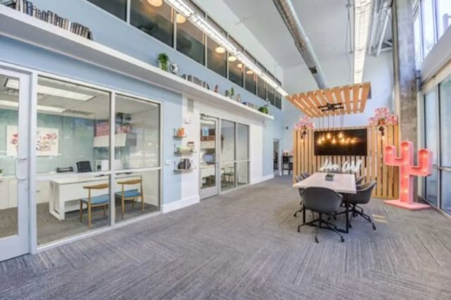 Glass-walled offices and meeting table space common area at The District on Apache in Tempe Student Accommodation