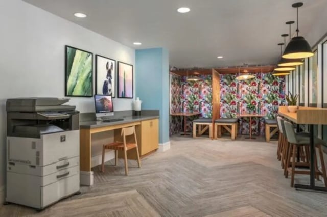Computer printer desk with artworks and study booths common area at The District on Apache in Tempe Student Accommodation