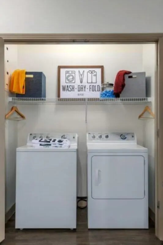 Washer dryer shelf with decor and baskets Laundry room at The District on Apache in Tempe Student Accommodation