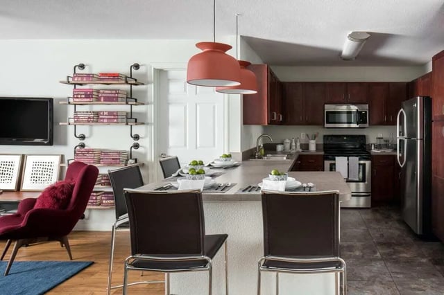 Kitchen island with chairs and full kitchen area. at The Kristi in Corpus Christi Student Accommodation