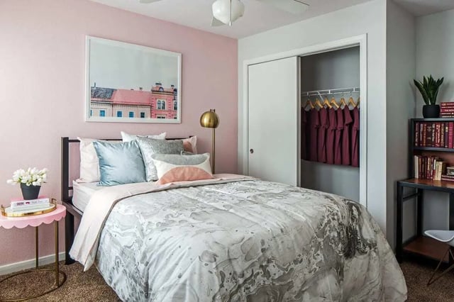 Bed with pillows artwork lamp closet bedroom at The Kristi in Corpus Christi Student Accommodation