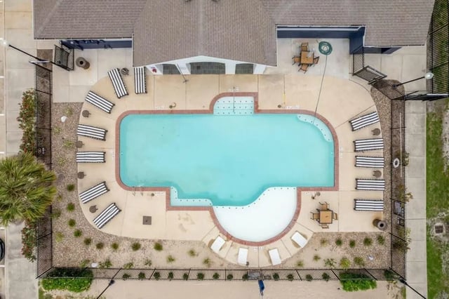 Pool with lounge chairs and tables Exterior at The Kristi in Corpus Christi Student Accommodation