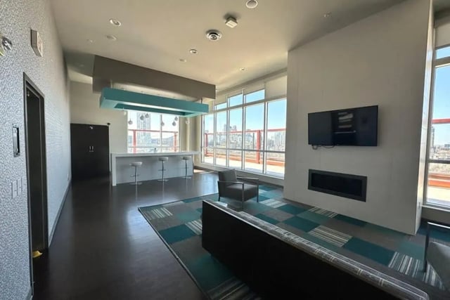 Sofa chair fireplace bar stools living area at The Bridges Dinkytown in Minneapolis Student Accommodation