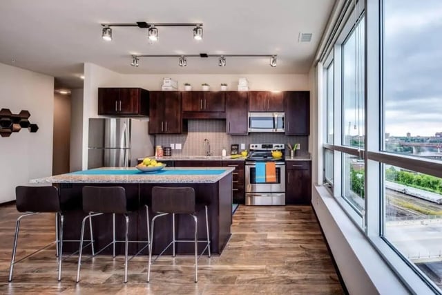 Modern kitchen island with stools and appliances kitchen at The Bridges Dinkytown in Minneapolis Student Accommodation