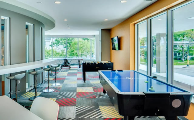 Air hockey table foosball table bar seating communal area at The Bridges Dinkytown in Minneapolis Student Accommodation