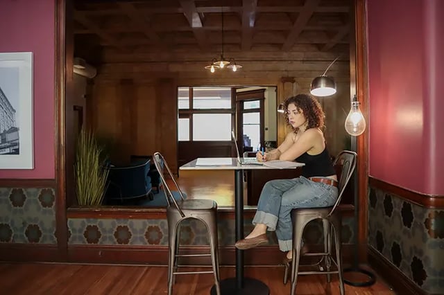Woman studying at table with laptop study area at Arc at Old Colony in Chicago Student Accommodation