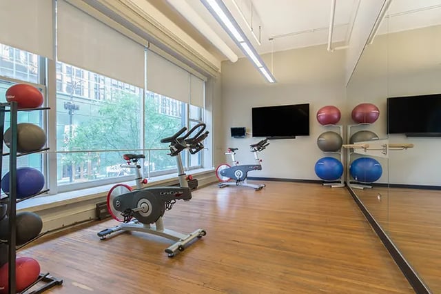 Spin bikes stability balls and TVs gym room at Arc at Old Colony in Chicago Student Accommodation
