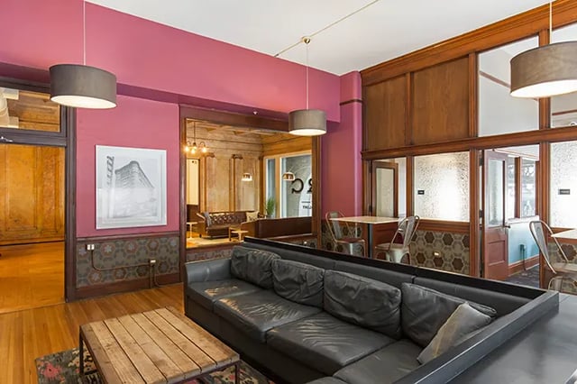 Leather sectional sofa wooden table art living area at Arc at Old Colony in Chicago Student Accommodation