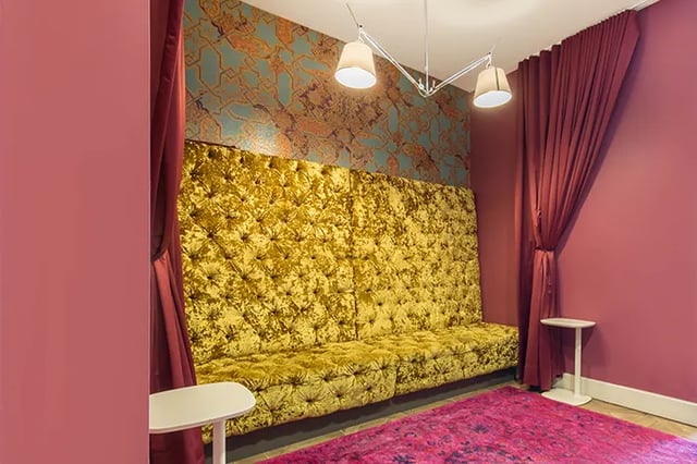 Tufted velvet sofa patterned wallpaper curtains side tables living room at Arc at Old Colony in Chicago Student Accommodation