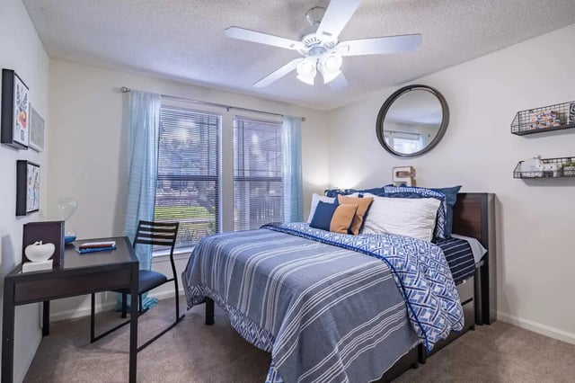 Bed desk chair ceiling fan mirror bedroom at Hideaway Gainesville in Gainesville Student Accommodation
