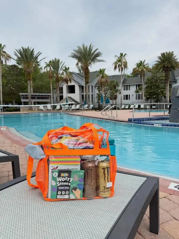 Bag with snacks and drinks by pool exterior at Hideaway Pool in Gainesville Student Accommodation