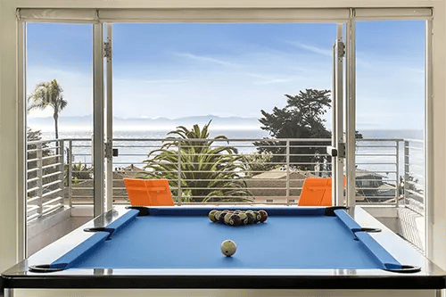 Blue pool table with balls ocean view balcony playing area at ICON in Goleta Student Accommodation