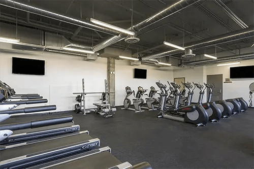 Treadmills elliptical machines weight rack gym equipment fitness area at ICON in Goleta Student Accommodation