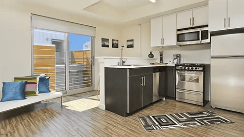 Sofa kitchen appliances and sliding door kitchen at ICON in Goleta Student Accommodation