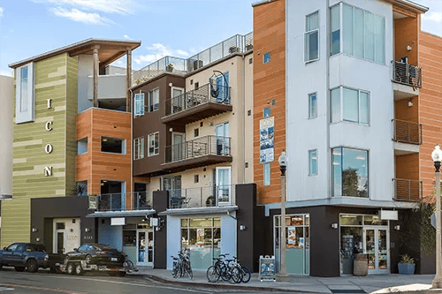 Modern apartment building with balconies and storefronts exterior at ICON in Goleta Student Accommodation