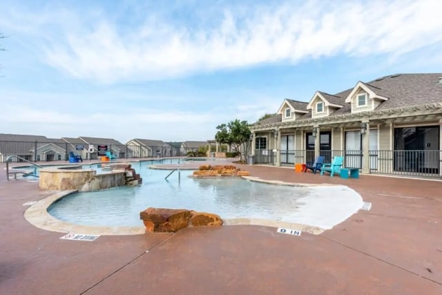 Pool with hot tub and chairs exterior at High View in San Antonio Student Accommodation