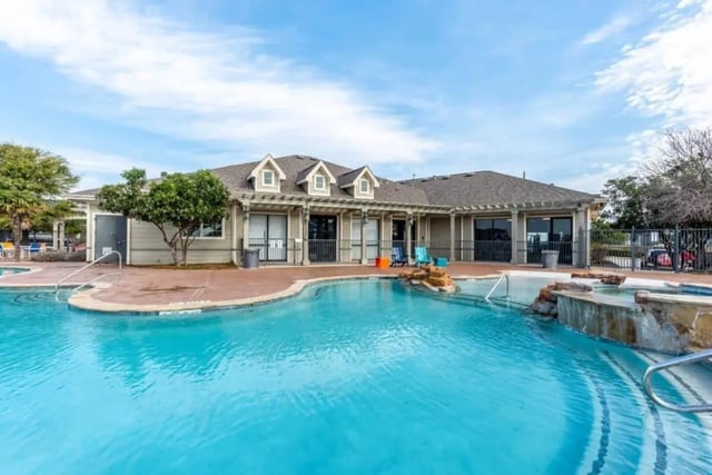 Swimming pool with hot tub and building exterior at High View in San Antonio Student Accommodation