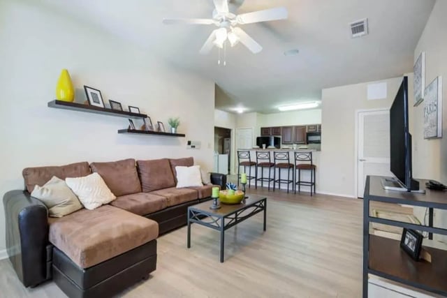 Brown sectional couch coffee table TV living room at High View in San Antonio Student Accommodation
