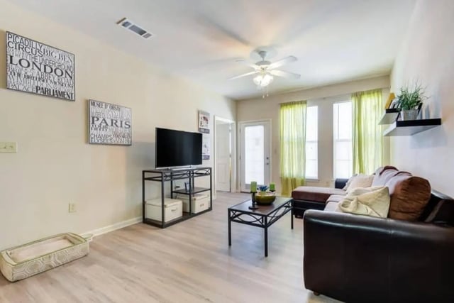Living room with couch television and coffee table Living room at High View in San Antonio Student Accommodation