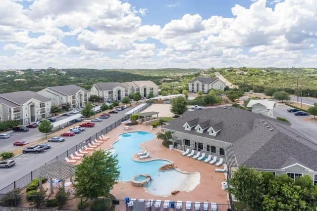 Apartment buildings pool and parking lot exterior at High View in San Antonio Student Accommodation