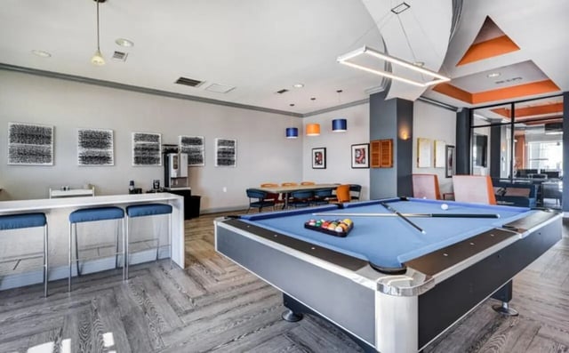 Pool table bar stools coffee machine dining table Living room at High View in San Antonio Student Accommodation