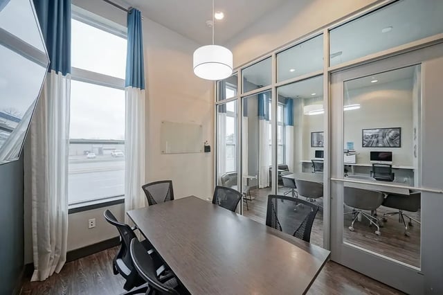 Table and chairs in study rooms with computers at Academy in Lincoln Student Accommodation