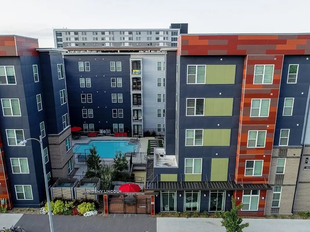 Apartment buildings pool and leasing center exterior at Academy in Lincoln Student Accommodation