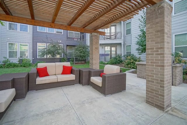 Patio seating area with sofas and chair exterior at Academy in Lincoln Student Accommodation