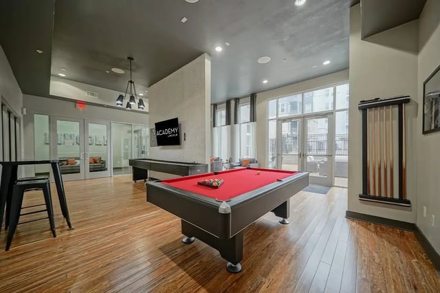 Pool table shuffleboard and seating area Game room at Academy in Lincoln Student Accommodation