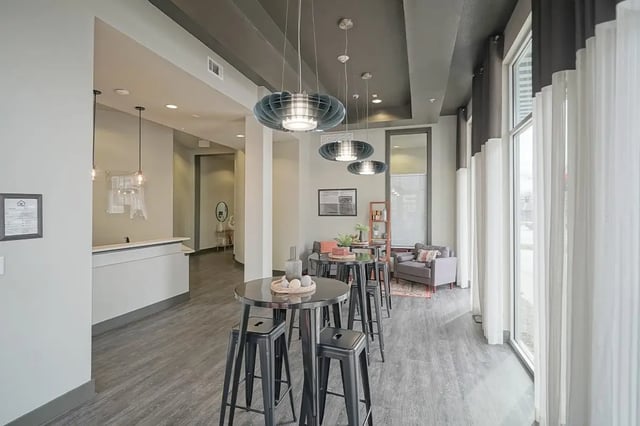 High tables with bar stools communal area exterior at Academy in Lincoln Student Accommodation
