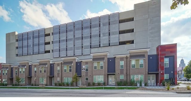 Townhouses with solar panels on parking garage exterior at Academy in Lincoln Student Accommodation