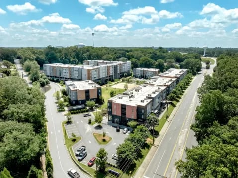 Modern apartment buildings with parking lot exterior at GrandMarc Clemson in Clemson Student Accommodation