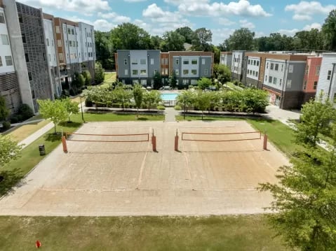 Volleyball court and pool area exterior at GrandMarc Clemson in Clemson Student Accommodation