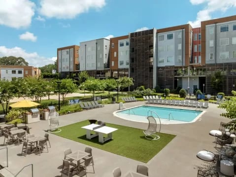 Modern apartments pool ping pong tables exterior at GrandMarc Clemson in Clemson Student Accommodation