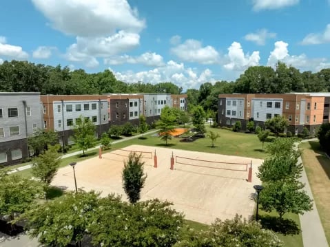Student housing with volleyball court exterior at GrandMarc Clemson in Clemson Student Accommodation