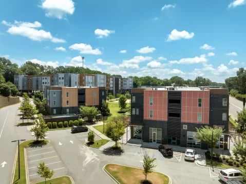 Modern apartment buildings with parking lot exterior at GrandMarc Clemson in Clemson Student Accommodation