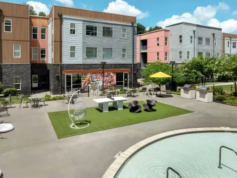 Courtyard with ping pong table grills pool exterior at GrandMarc Clemson in Clemson Student Accommodation