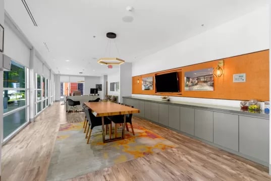 Dining table and chairs with TV common area at GrandMarc Clemson in Clemson Student Accommodation