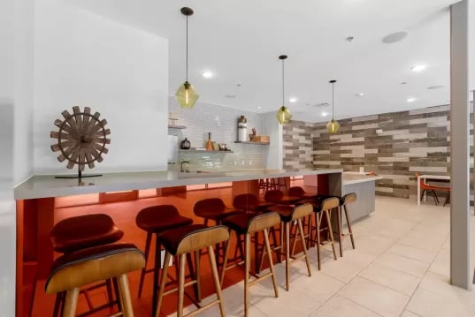Bar stools at counter with decorative wheel communal area at GrandMarc Clemson in Clemson Student Accommodation