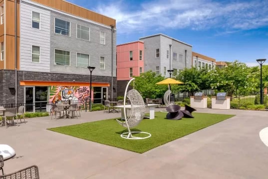 Outdoor seating grilling area with modern buildings exterior at GrandMarc Clemson in Clemson Student Accommodation