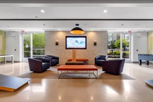 Four chairs TV foosball table living room at GrandMarc Clemson in Clemson Student Accommodation