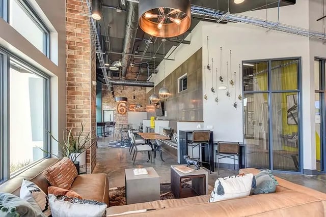 Leather sofas dining table and bar stools common area at Academy65 in Sacramento Student Accommodation