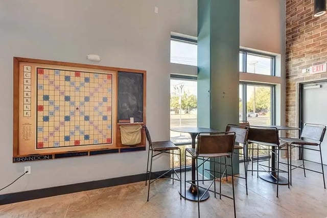 Scrabble board seating area bar stools and table playing area at Academy65 in Sacramento Student Accommodation