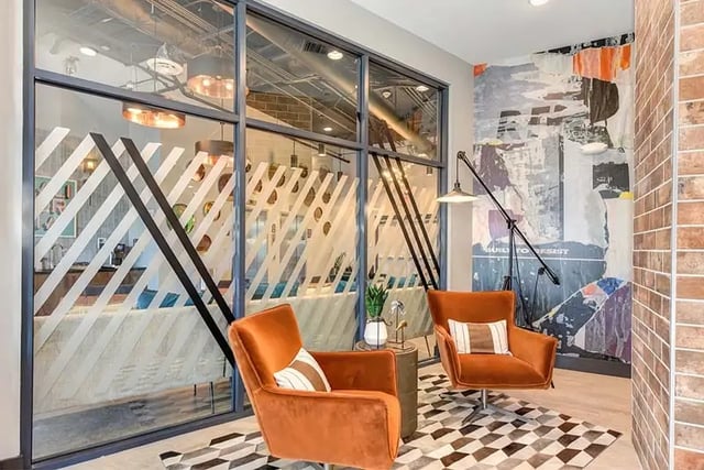 Two orange chairs modern art abstract wallpaper living room at Academy65 in Sacramento Student Accommodation