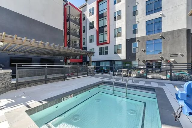 Hot tub area next to building exterior at Academy65 in Sacramento Student Accommodation