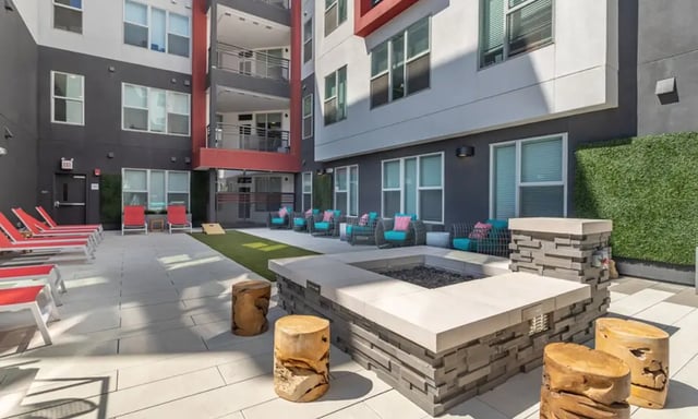 Patio with lounge chairs fire pit outdoor seating exterior at Academy65 in Sacramento Student Accommodation