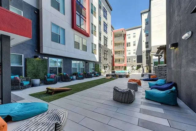 Courtyard with beanbags lounge chairs and artificial turf exterior at Academy65 in Sacramento Student Accommodation